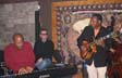Stan listens while George Benson plays Stan's guitar with Gerard Gibbs on piano
